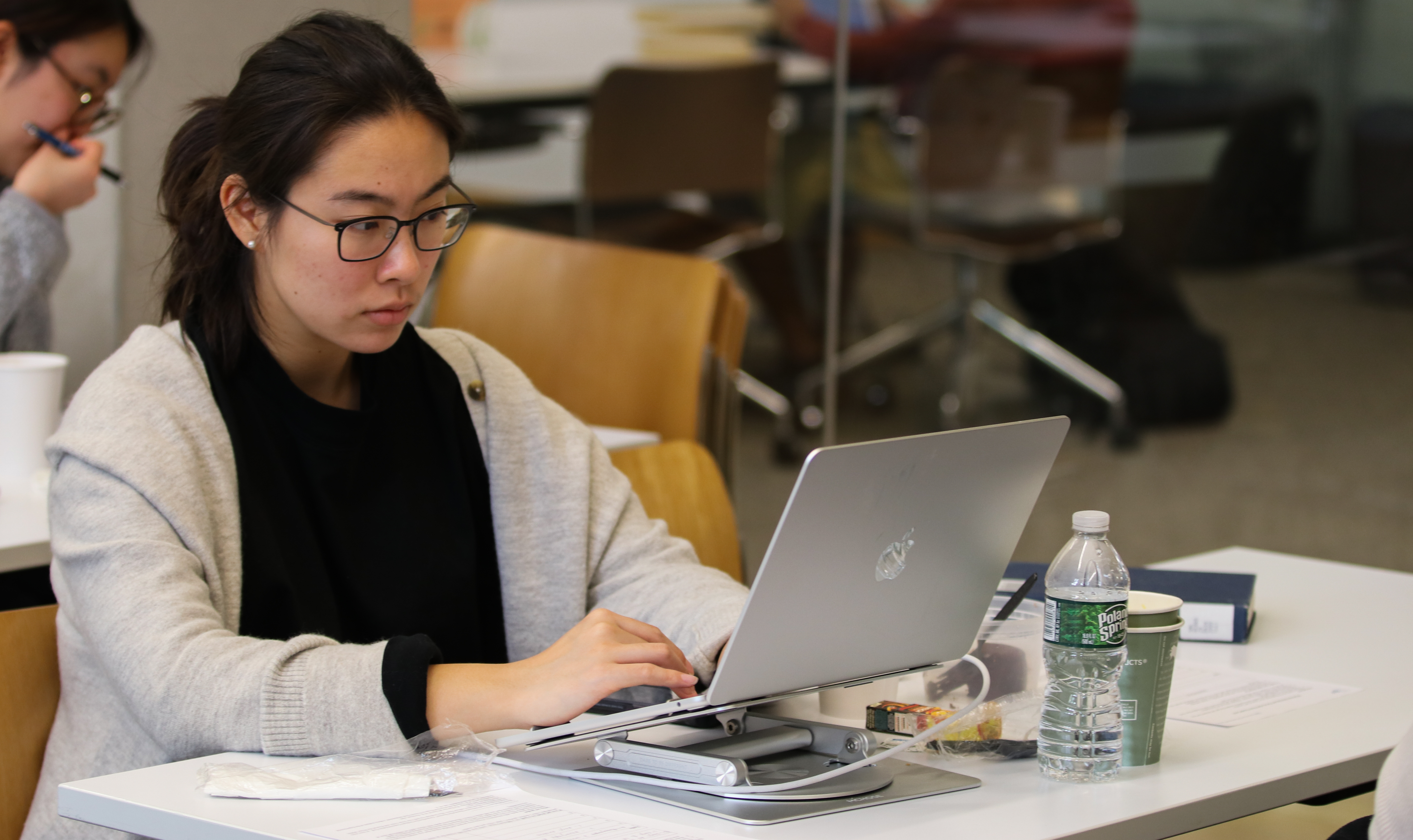 A Yale graduate student writing a paper on a laptop.