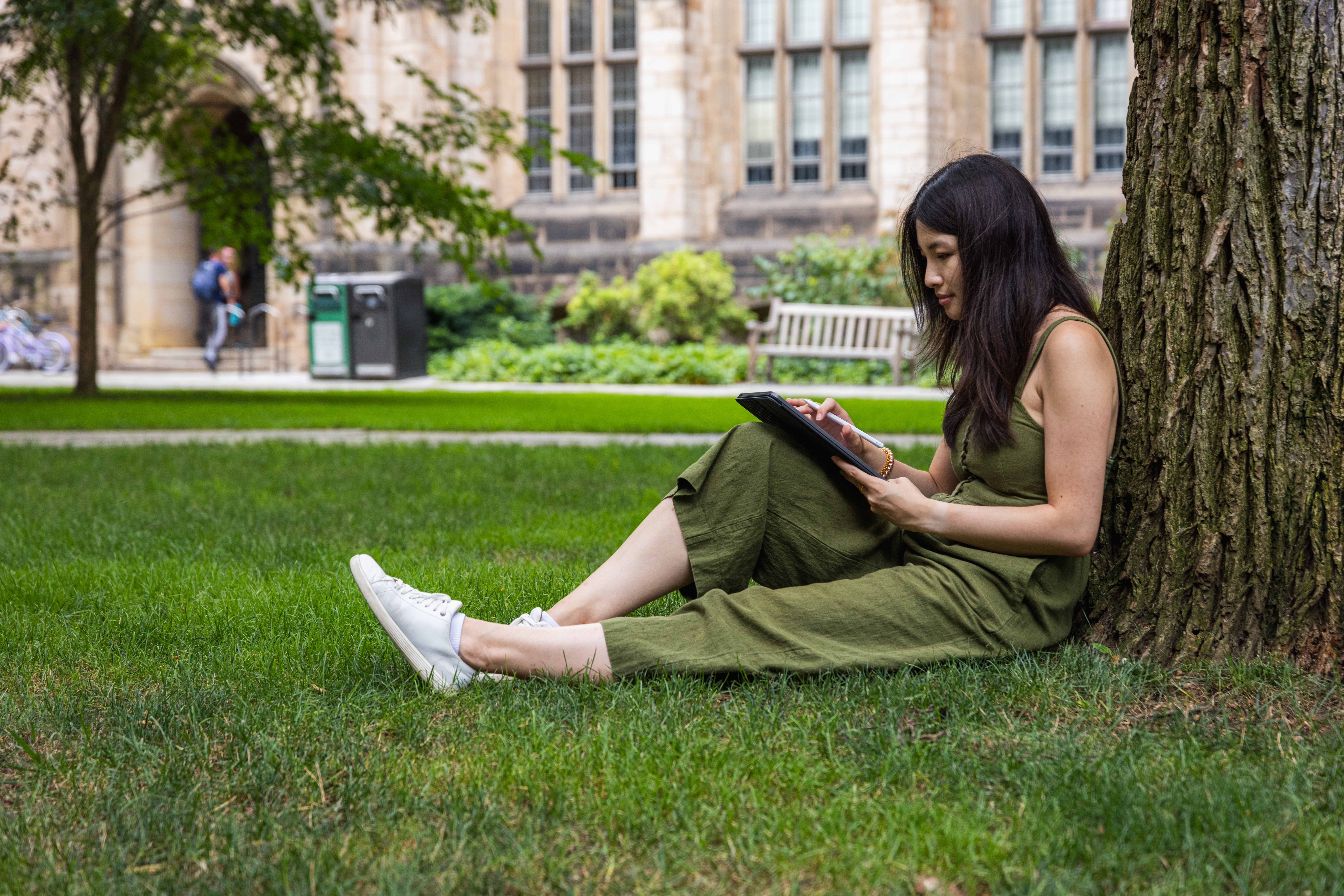 Young Woman learns on iPad outside