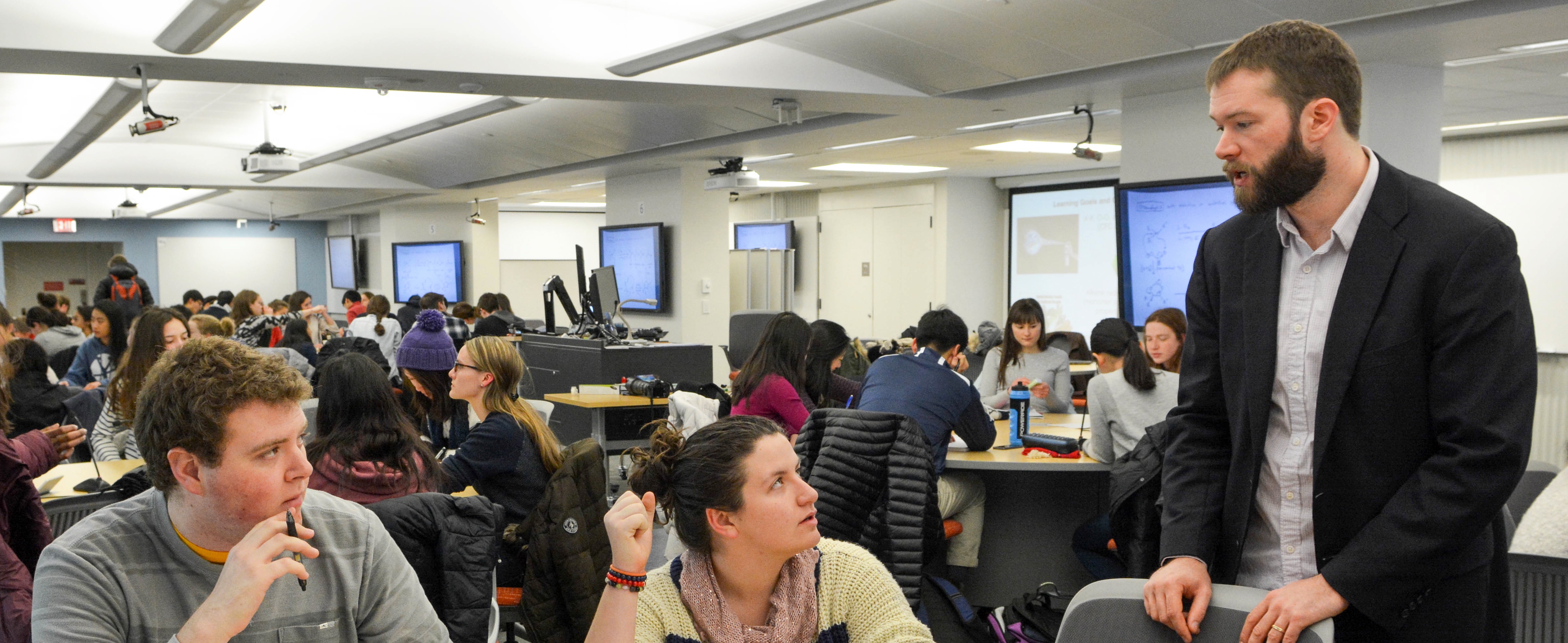 Instructor speaking with students
