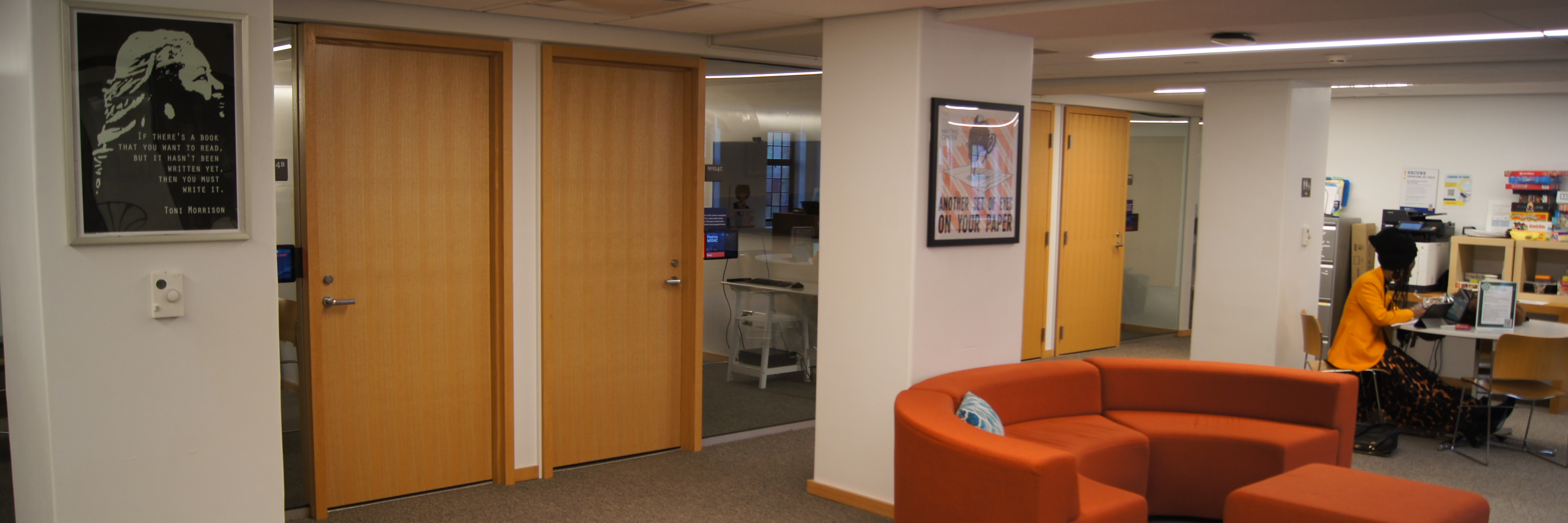 The doors and glass walls of four writing consultation offices on the Poorvu Center mezzanine.