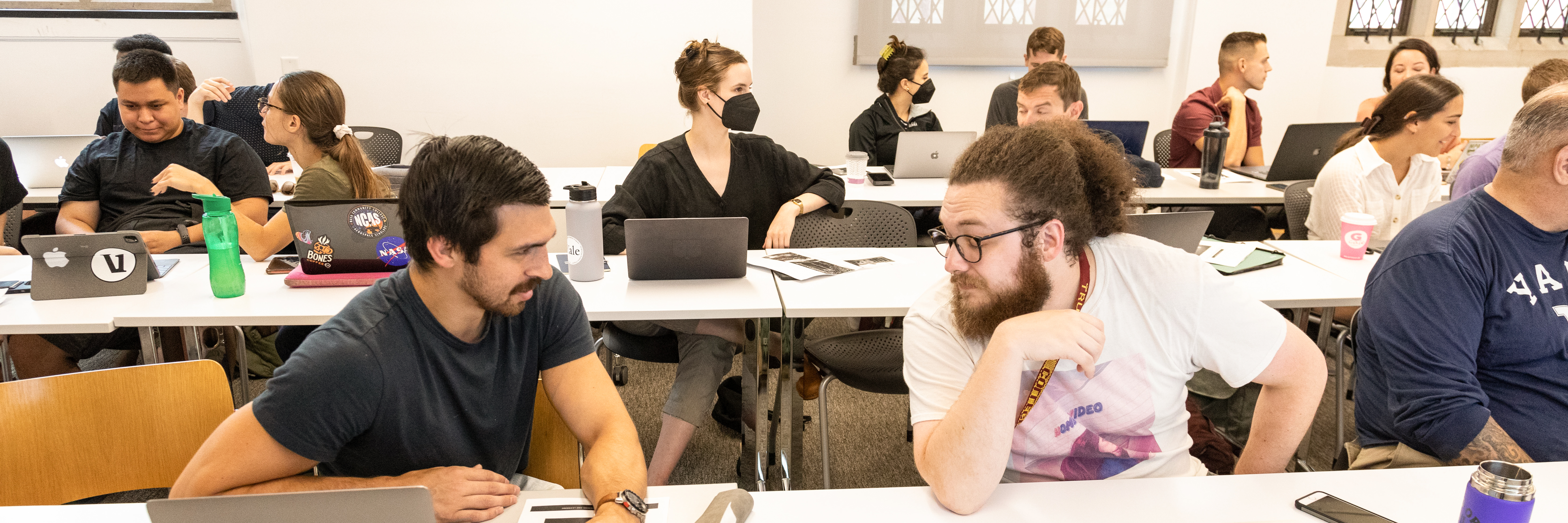 Yale grad students discussing in pairs during a workshop.
