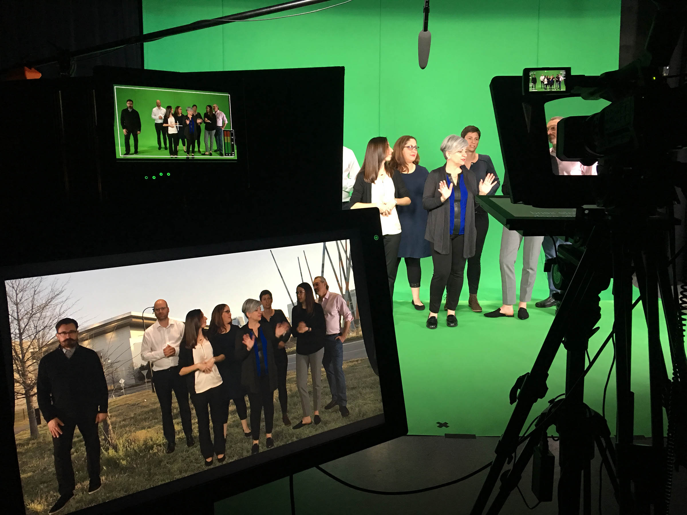 Various people on a greenscreen set.