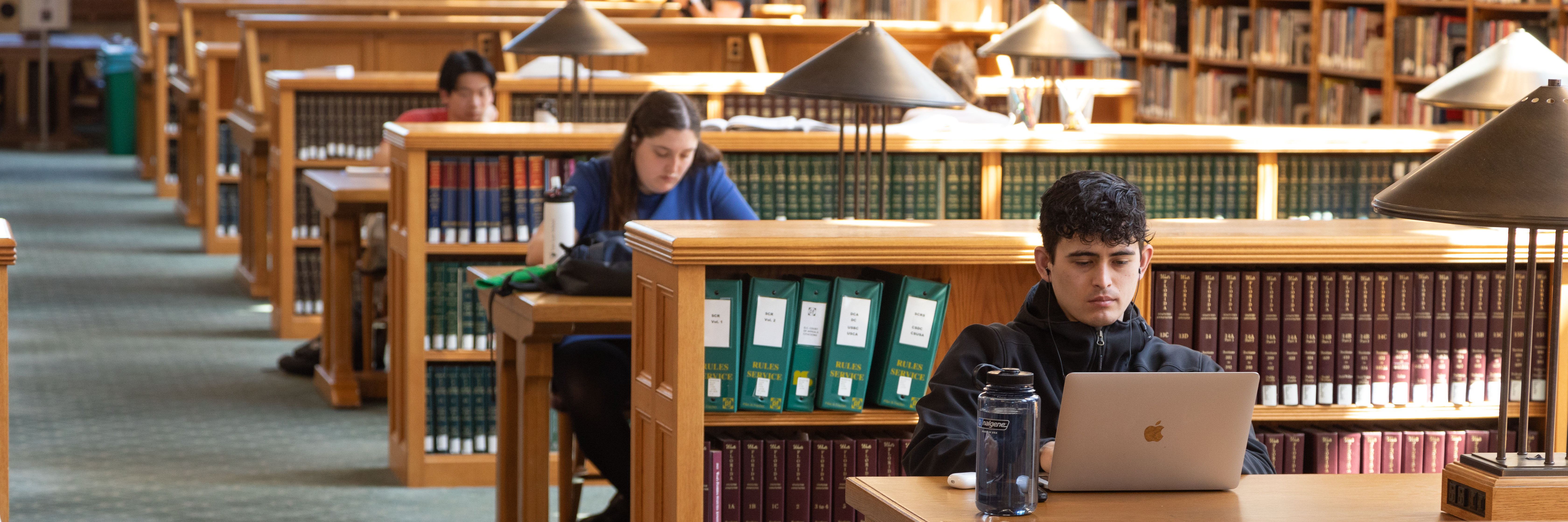 Students writing on laptops in the Yale Law School Library.