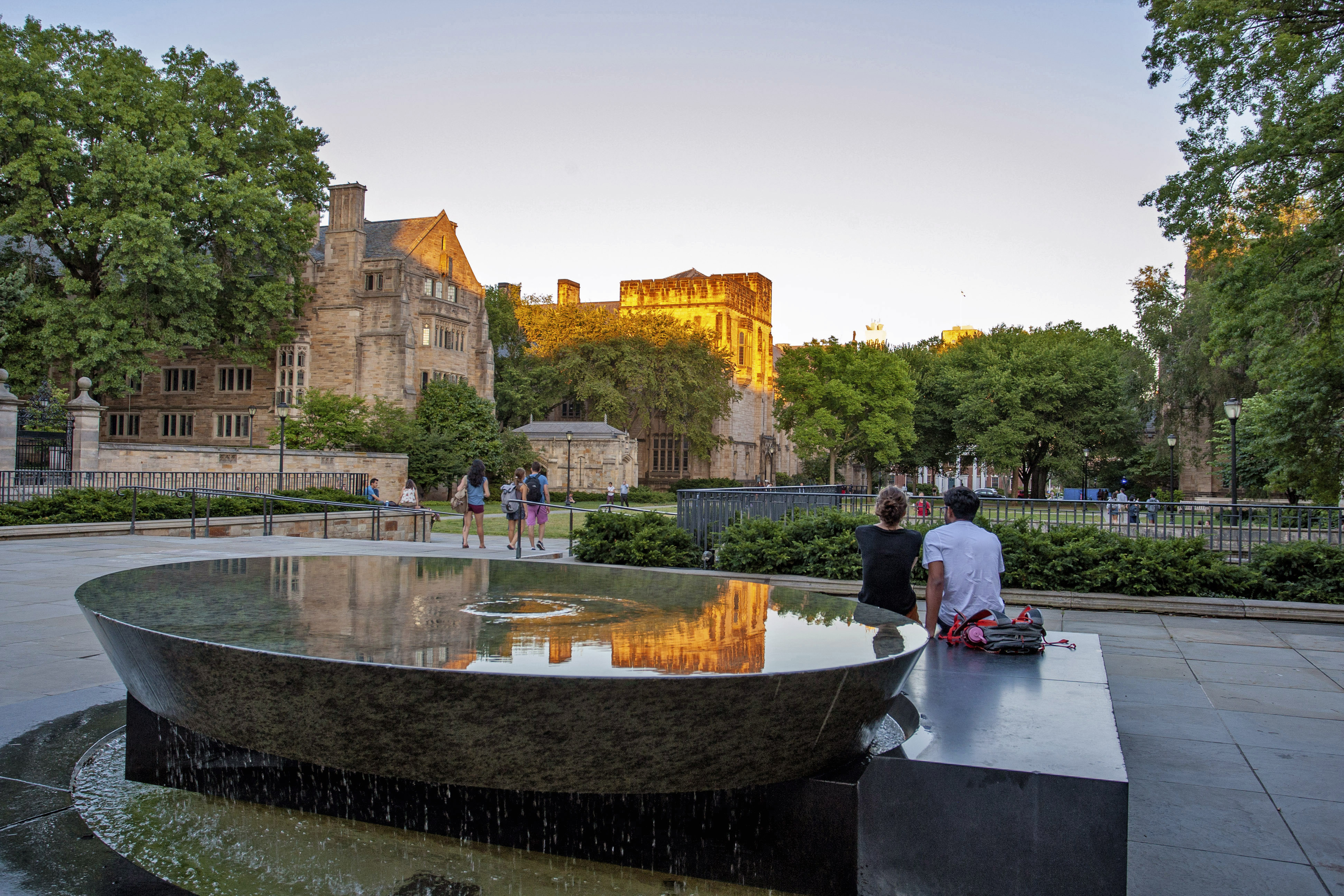 Two students sit looking at Cross Campus.