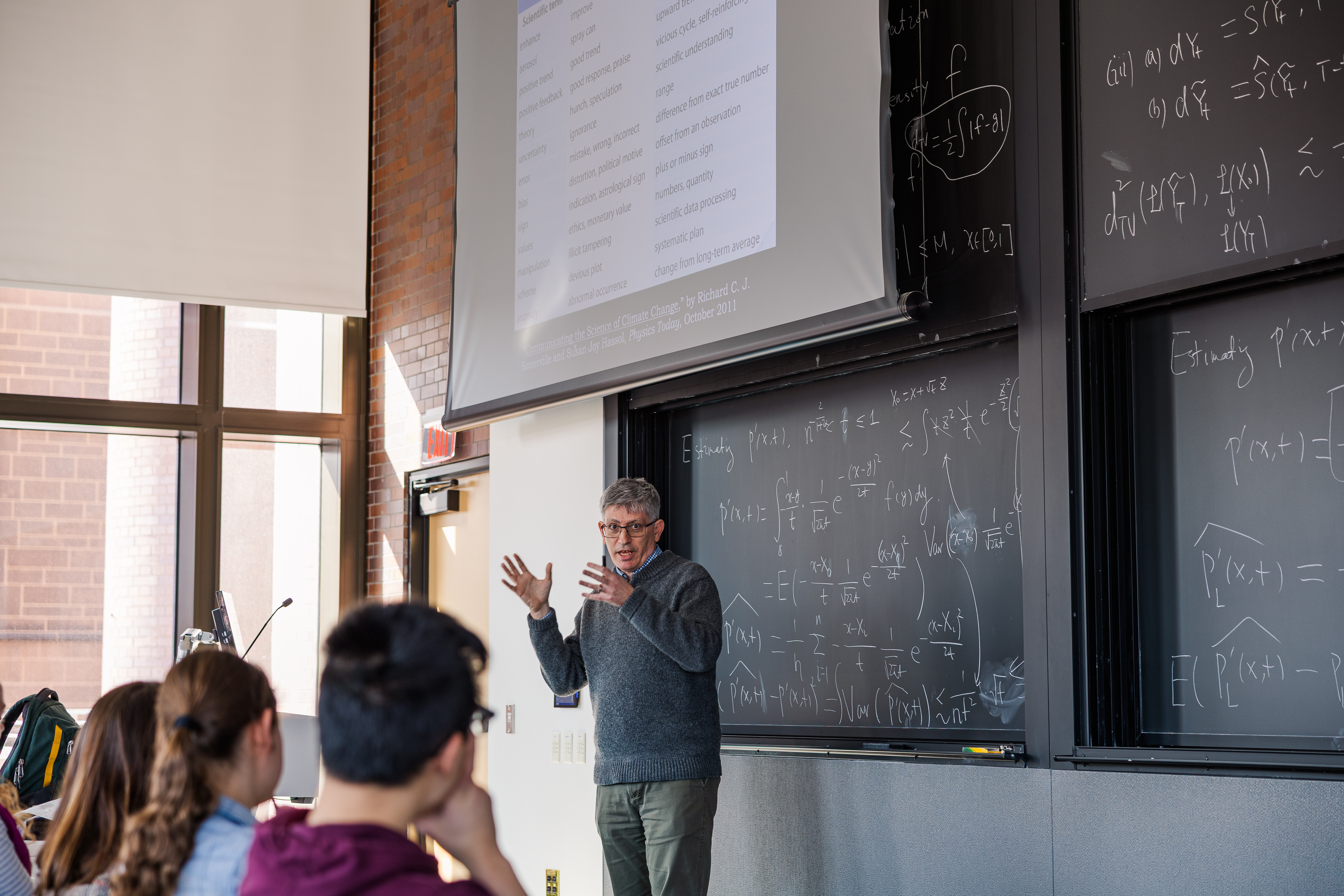 Person stands in front of blackboard