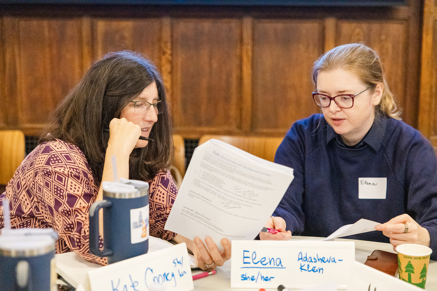 Two faculty review a document during Course (Re)Design.