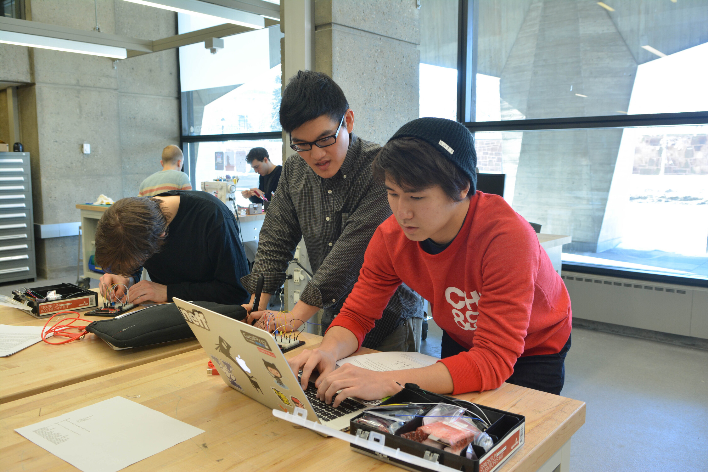 Two students work on a laptop.