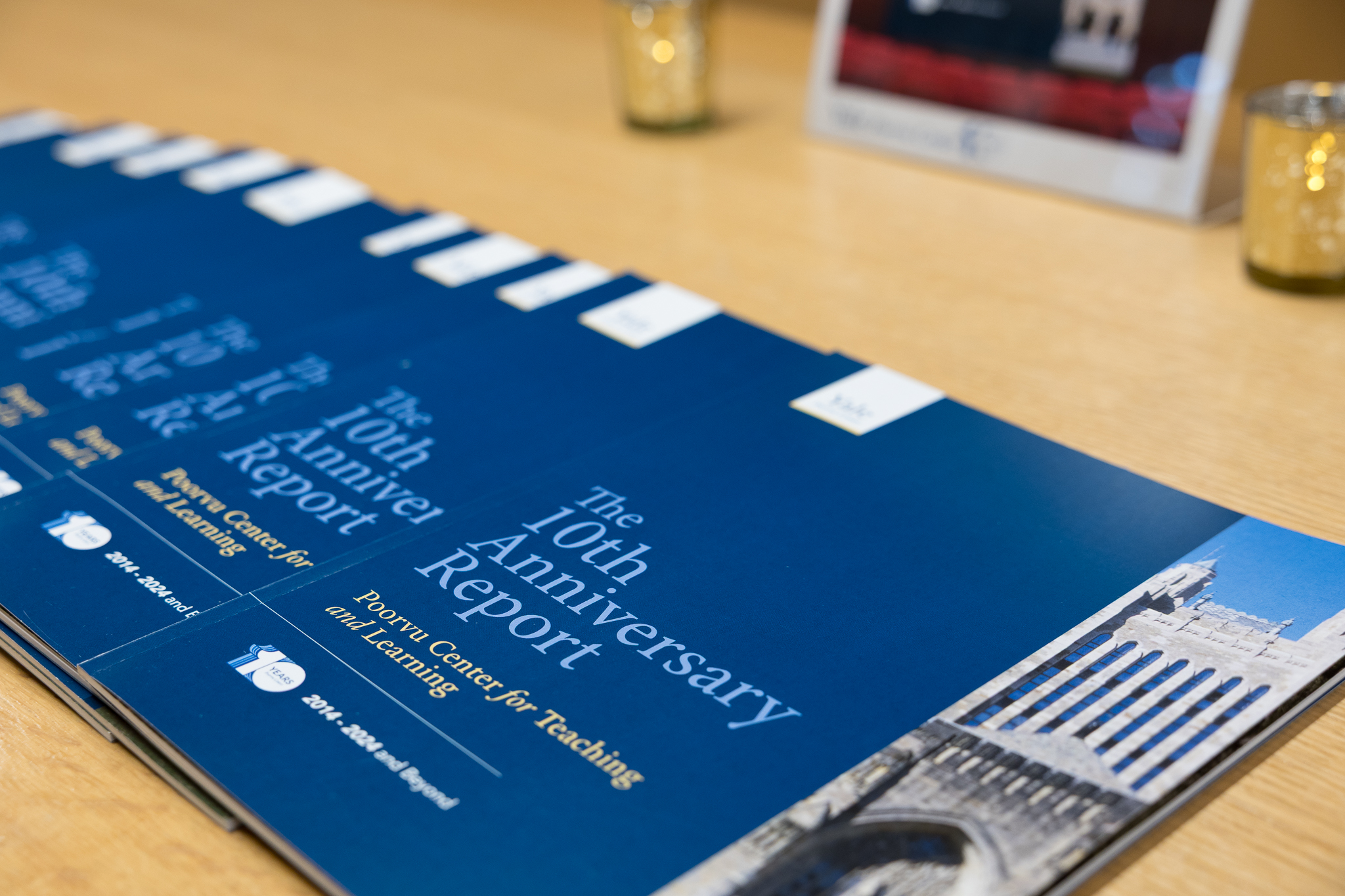 Copies of the Poorvu Center's 10th anniversary report spread on a table