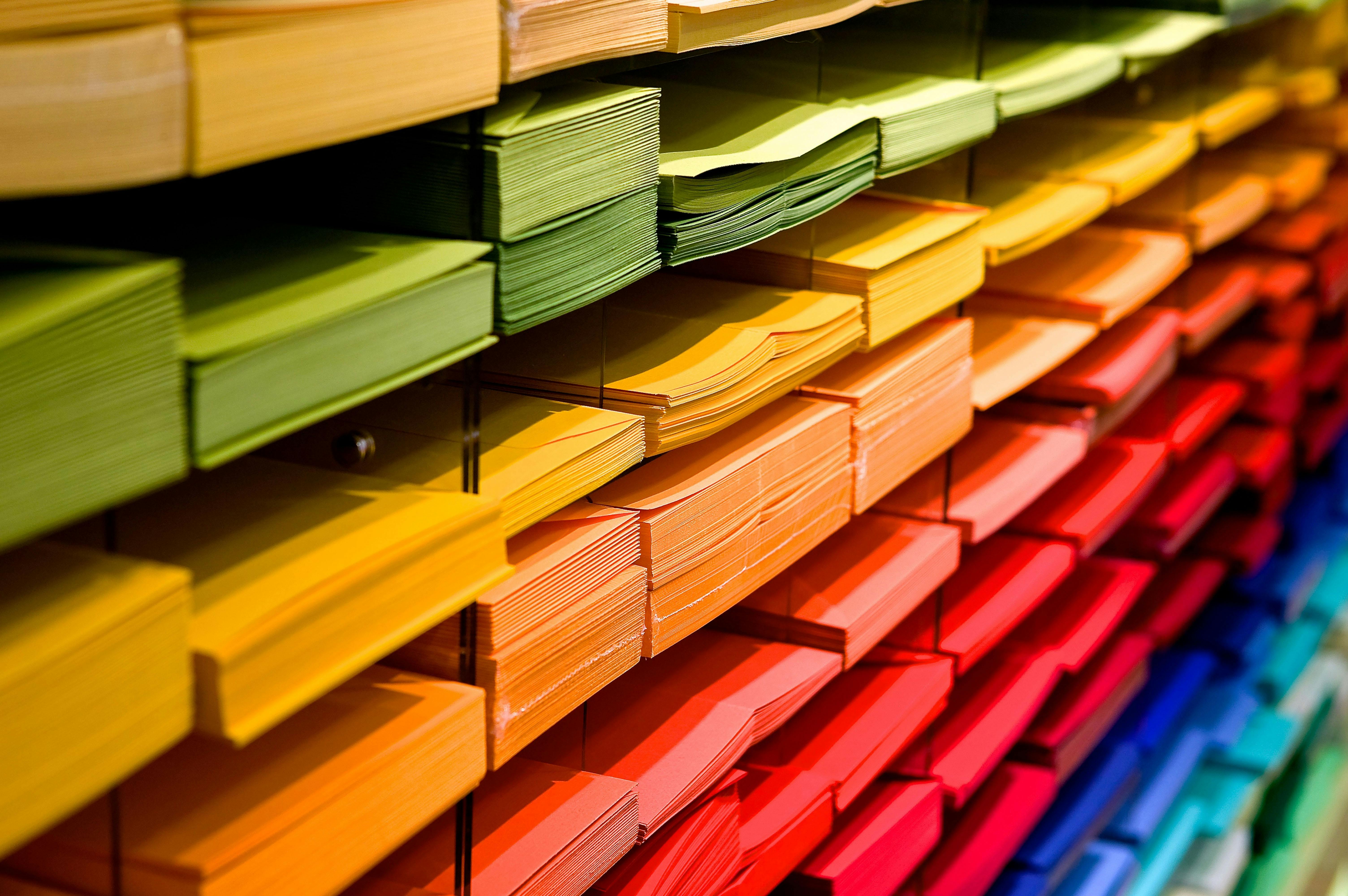 rows of stacked paper sheets organized by color