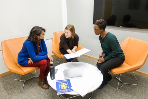 Three women meeting in a room in the new Center