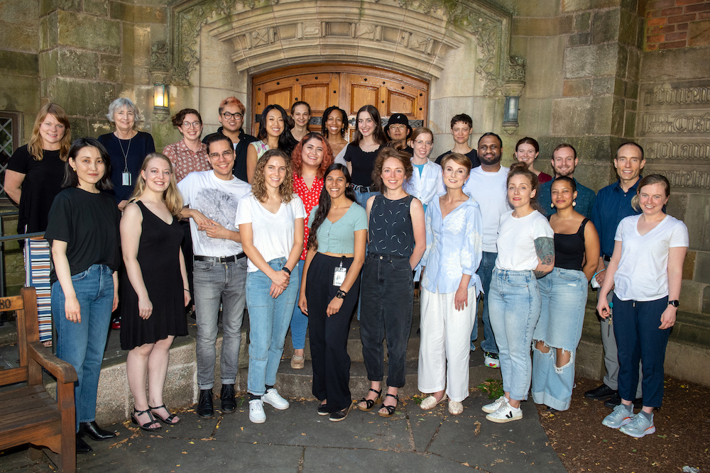 Group photo of 20 Graduate Writing Lab staff and fellows, standing in a Yale courtyard.