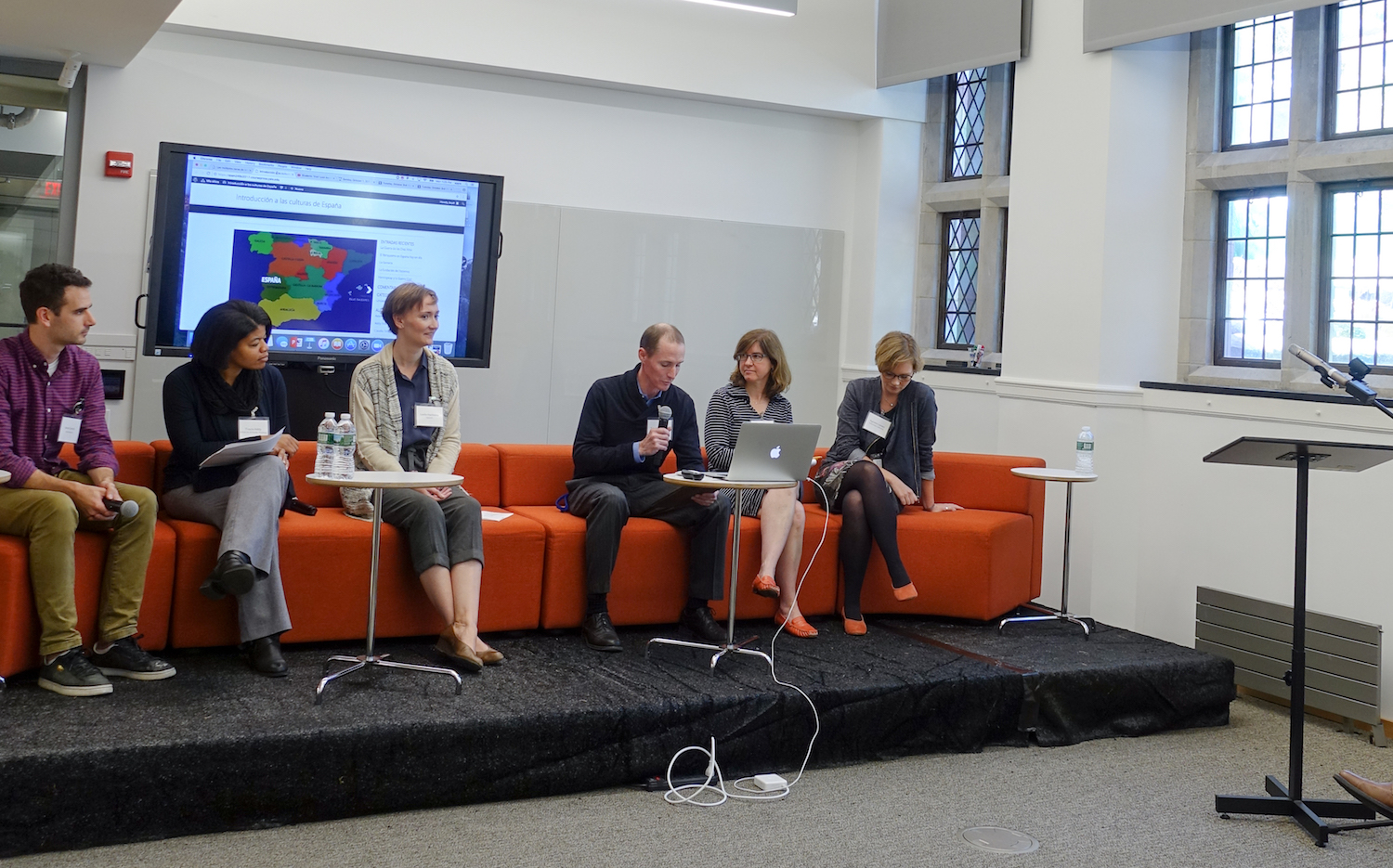 Brett C. Smith, Tracie Addy, Leslie Harkema, Trip Kirkpatrick, Kathryn Slanski, Agnete lassen present, while sitting on an orange coach during the Technology Forum