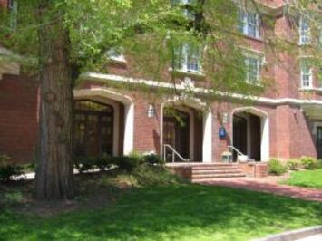 Yale building on Temple Street on sunny  day, with leafy tree in front of it.