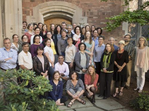 A group of 55 Yale faculty and staff members standing in the courtyard at the Hall of Graduate Studies 