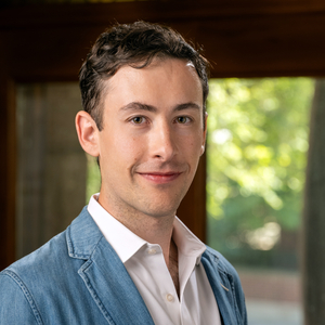 Alexander Ekserdjian is a man wearing a blue sports coat and white collared shirt.