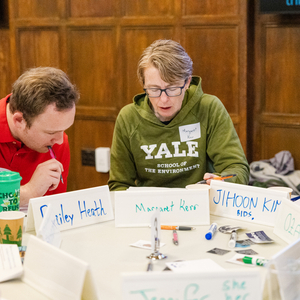 Faculty working together at a table.
