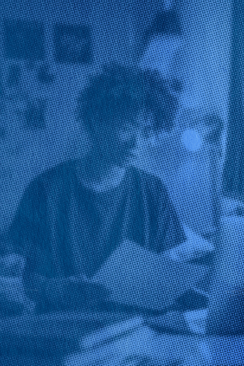 A student reviewing the course syllabus in their dorm room