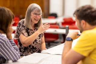 Teachers talking across a table