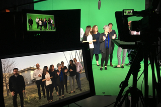Various people on a greenscreen set.