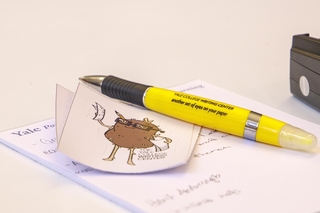 A sticker of the Writing Center's spud mascot and yellow Writing Center pen