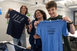 Three Writing Partners pose with new Writing Center t-shirts
