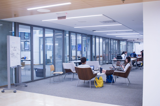Image of Poorvu Center workspace with two students seated.
