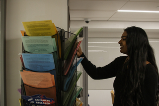 student looking at handouts