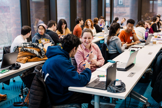Students talking in pairs during a Graduate Writing Lab workshop.