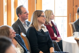 Faculty standing together during presentation.