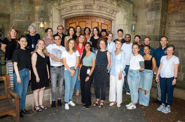 Group photo of 20 Graduate Writing Lab staff and fellows standing in a Yale courtyard.