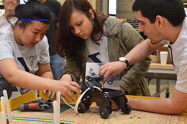 Three students work on an Engineering Project, two female and one male