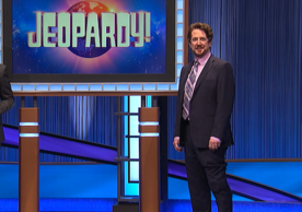 Alfred Guy stands on the stage of the TV show Jeopardy