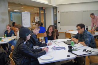 Graduate students working together in a writing workshop