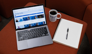 A laptop featuring the Yale Online learning catalog.