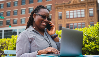 Woman on a cellphone with laptop open