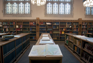 Reading Room in Sterling Memorial Library, with a book open