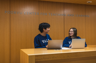 Two students work on laptops at the Poorvu Center