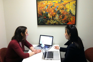 A Graduate Writing Lab Fellow giving feedback to a writer in a Poorvu Center consultation office.