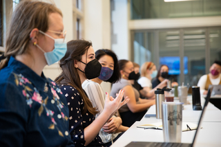 Students around a table in masks