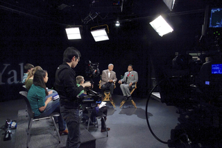 Studio talk show with production crew, guests, and audience