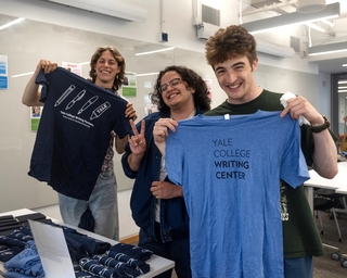 Three Writing Partners pose with new Writing Center t-shirts