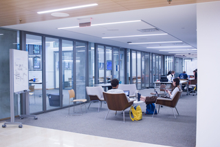 Image of Poorvu Center workspace with two students seated.
