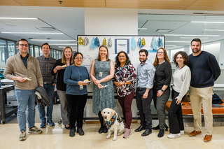 Members of the Poorvu Center staff pose with Heidi the dog to celebrate April's Poorvu 10 event