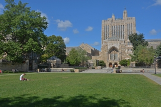 Sterling Memorial Library viewed from Cross Campus, with Gothic architecture and surrounding trees.