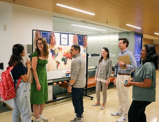 Poorvu Center colleagues gather for discussion in a hallway