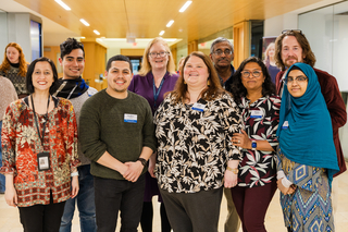 Poorvu Center staff members pose together in the hallway of our main location. 